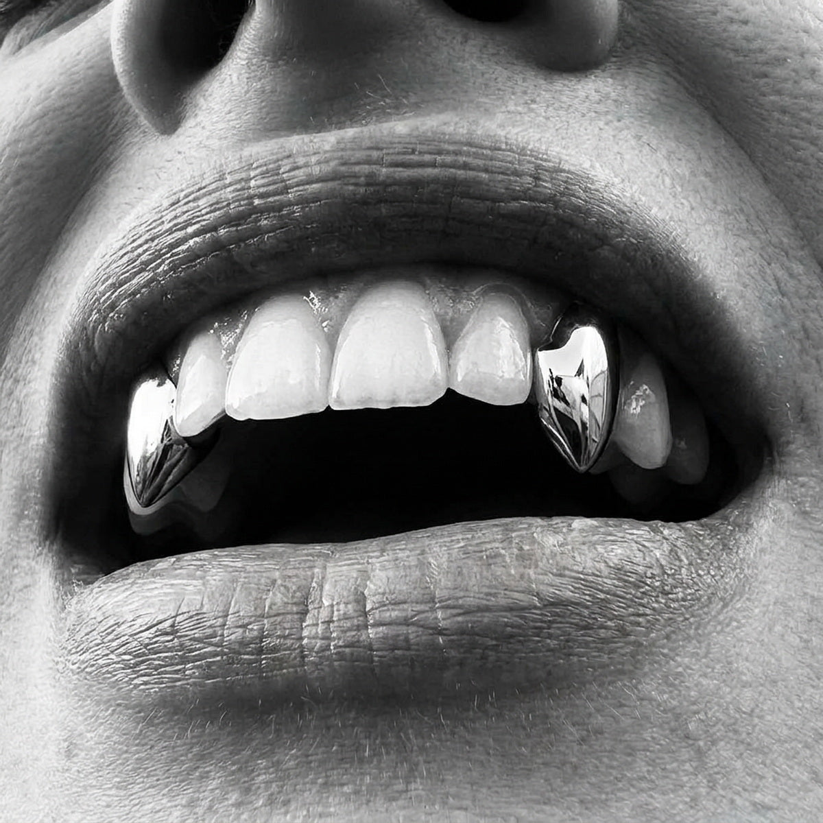 Customer wearing custom Vampire Fangs gold grillz
