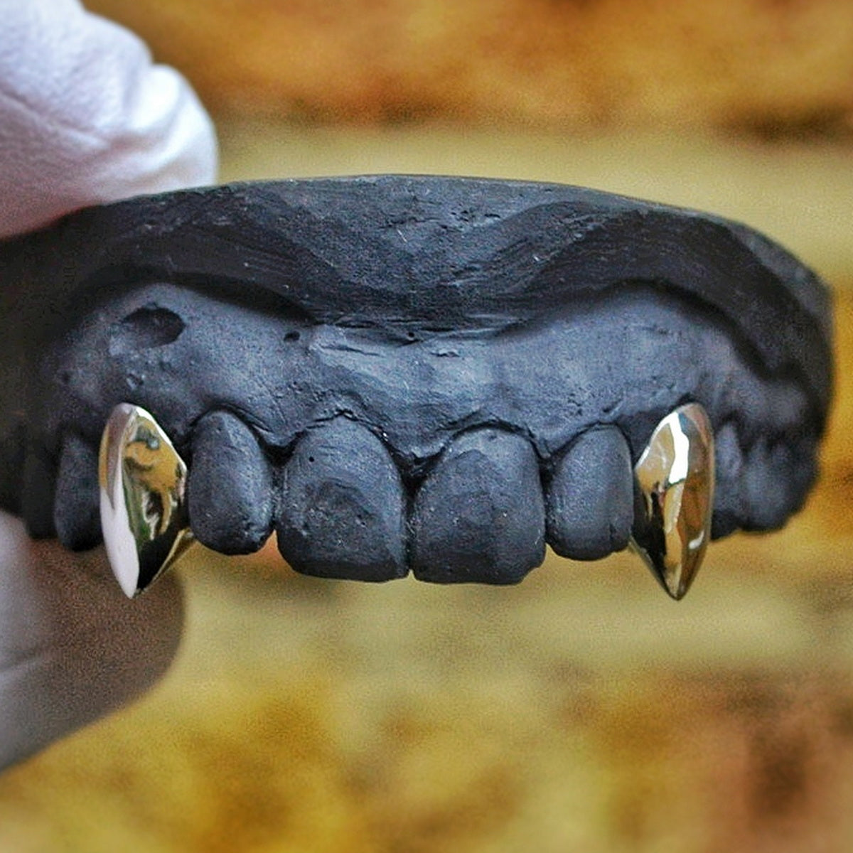 Customer wearing custom Vampire Fangs gold grillz